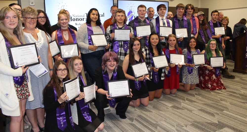 Students and their teachers and counselor pose with certificates