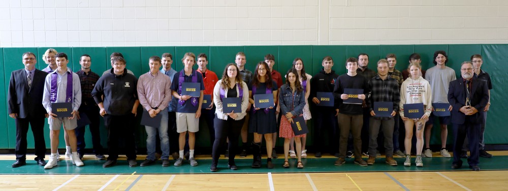 Welding and HVAC students pose with their completion certificates and instructional staff