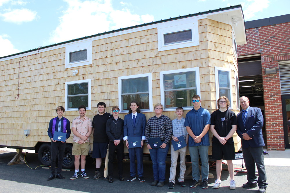 Students pose with tiny house