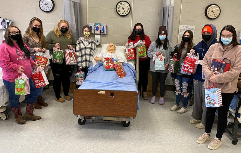 Students pose with patient dummy